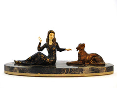 Medium sized "Chryselephantine" lady with Borzoi (Russian wolfhound), mounted on a Portoro marble base by Scali, France 1930s. Spelter and Ivoreen. Overall length 49 cm  19.30".